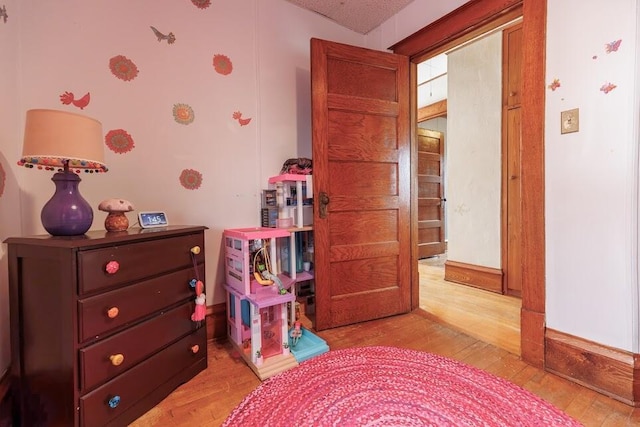 playroom featuring light wood-style flooring