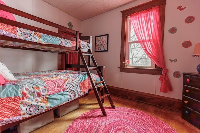 bedroom featuring baseboards and hardwood / wood-style floors