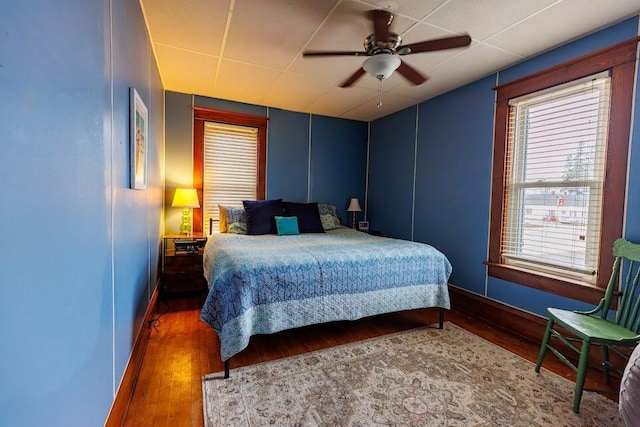 bedroom with wood finished floors and a ceiling fan