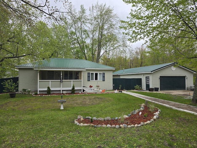 8393 E E W Branch Rd, Saint Helen, MI 48656 - ranch-style home with a garage, an outbuilding, a metal roof, and a front yard