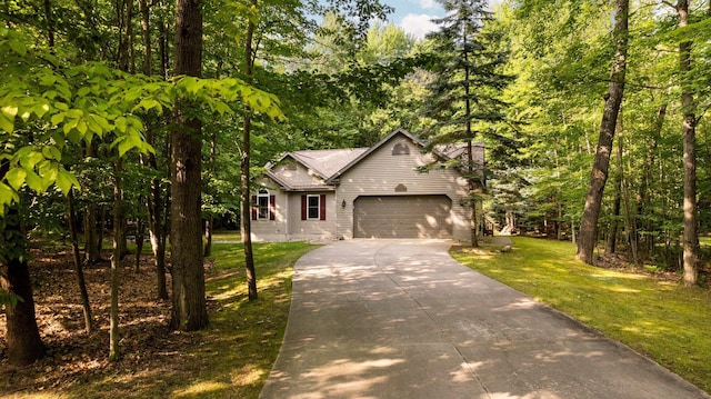 view of front facade with a front lawn, concrete driveway, and a garage