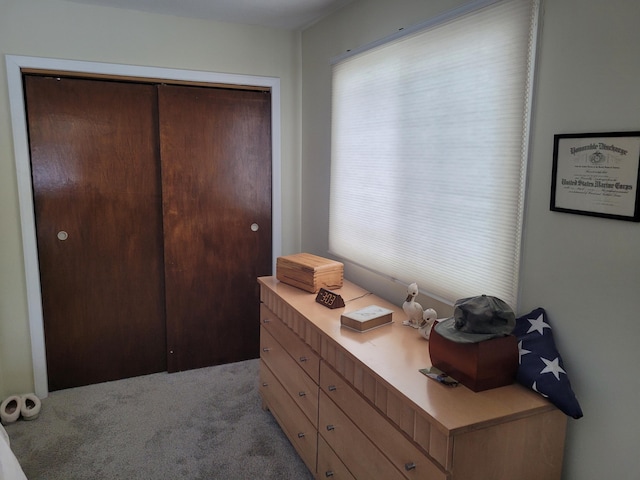 bedroom featuring a closet and light carpet