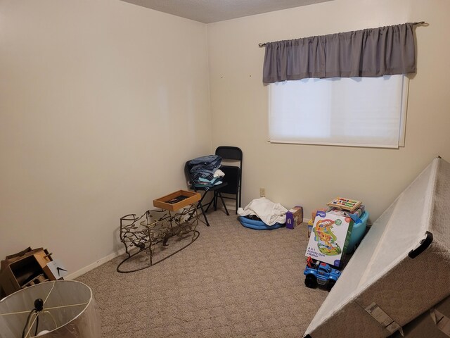 game room featuring carpet flooring and baseboards