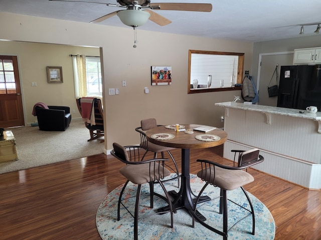 dining space featuring ceiling fan, baseboards, and wood finished floors