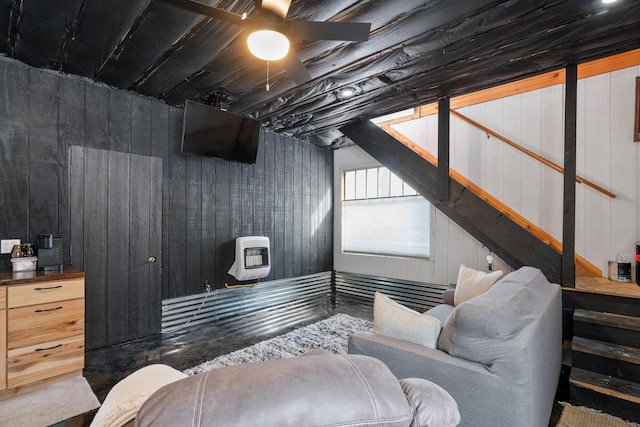 bedroom featuring heating unit and a ceiling fan