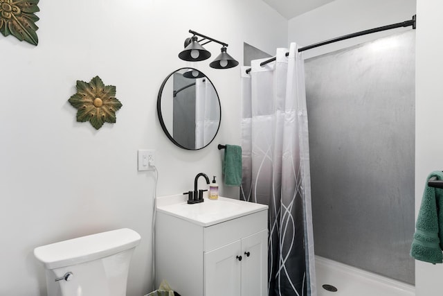 full bath featuring vanity, a shower stall, and toilet