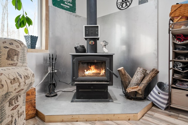 room details with a wood stove and wood finished floors