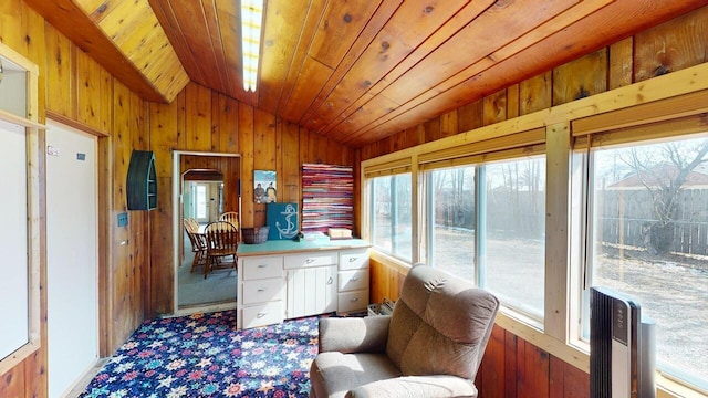 sunroom featuring lofted ceiling, a healthy amount of sunlight, and wooden ceiling