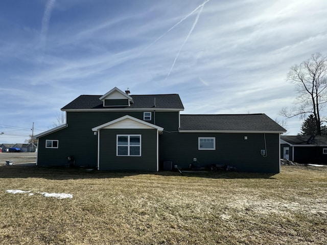 rear view of house featuring a yard