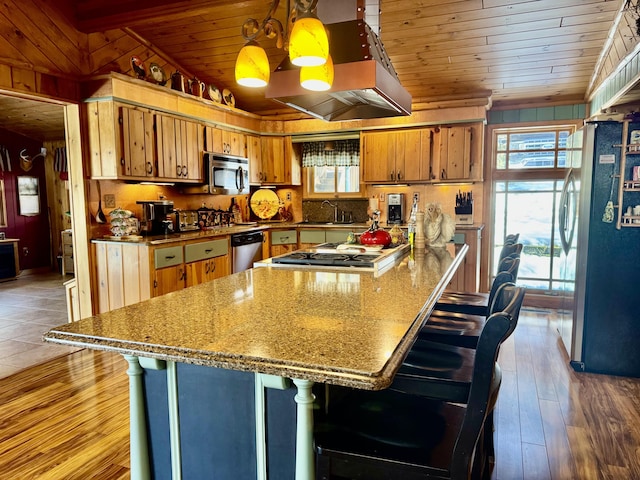 kitchen with a sink, dark wood finished floors, stainless steel appliances, brown cabinetry, and wood ceiling