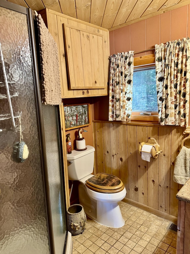 bathroom featuring wooden walls, toilet, wood ceiling, and a shower stall