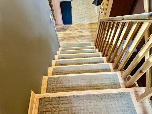 stairway featuring wood finished floors