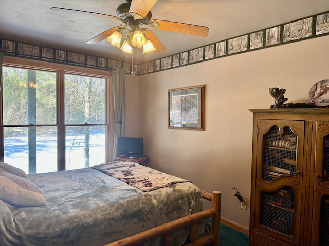 bedroom with baseboards and a ceiling fan