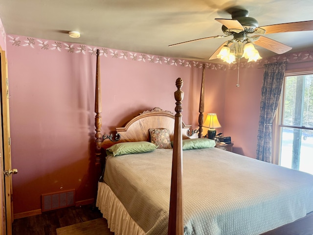 bedroom with visible vents, ceiling fan, and wood finished floors