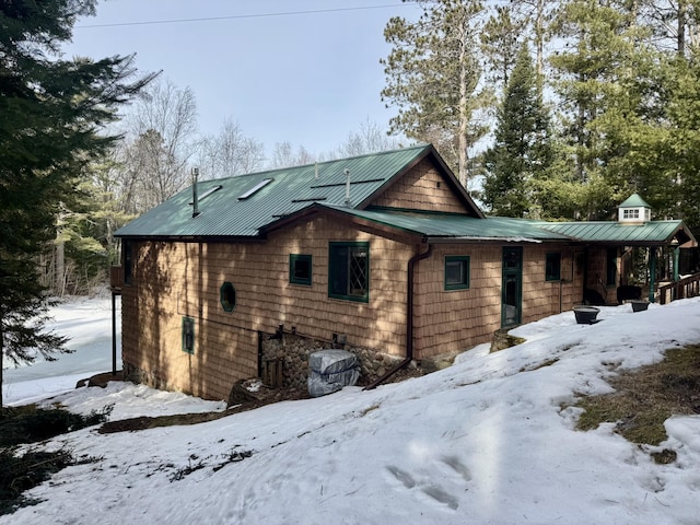 view of snowy exterior featuring metal roof