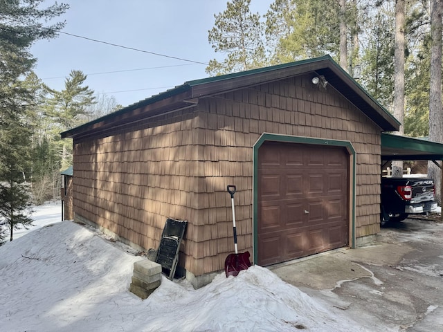 garage featuring a carport and driveway