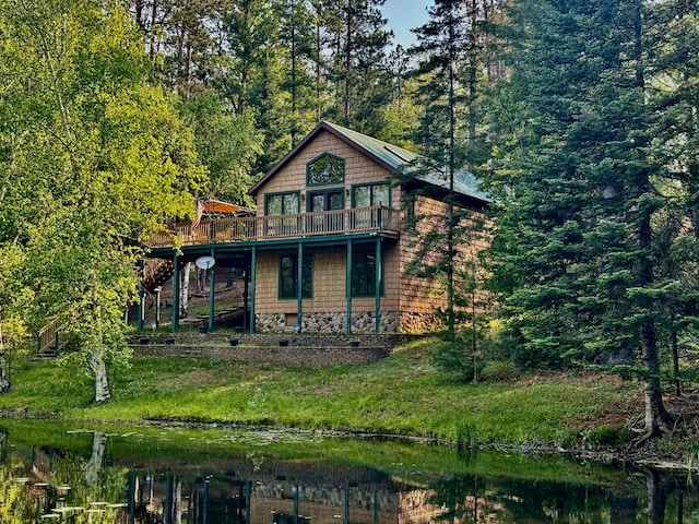 2305 Kirk Rd, Fairview, MI 48621 - view of front facade featuring a deck with water view