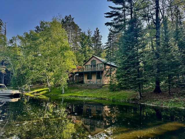 2305 Kirk Rd, Fairview, MI 48621 - back of property with a forest view and a deck with water view