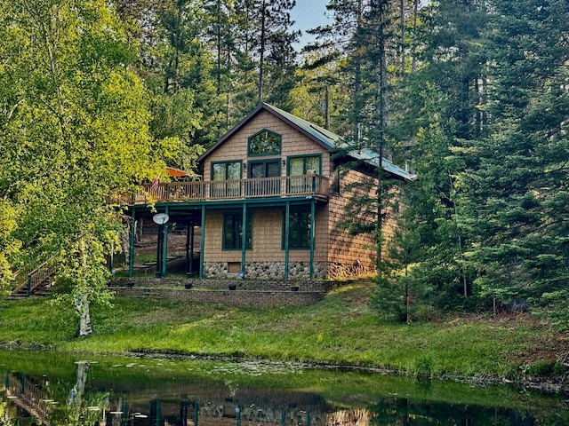 2305 Kirk Rd, Fairview, MI 48621 - view of front of house with a wooden deck and a forest view