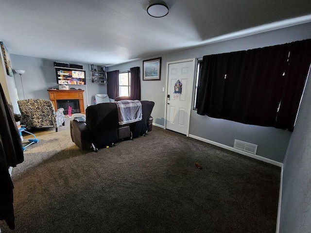 living area with visible vents, baseboards, and carpet flooring