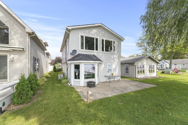 rear view of property featuring a yard and a patio