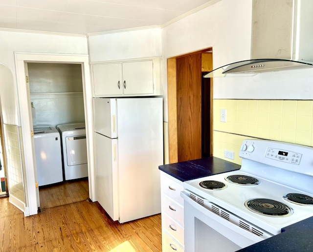 kitchen with light wood-type flooring, washer and dryer, white cabinetry, white appliances, and wall chimney exhaust hood