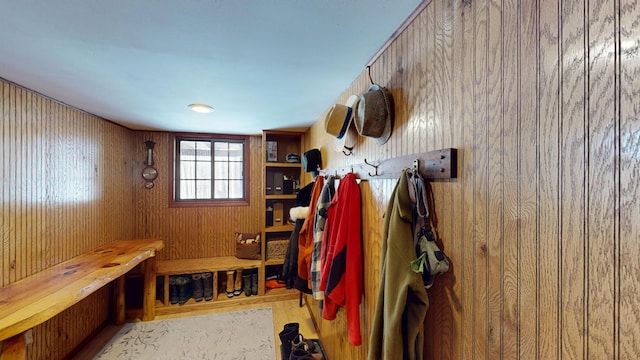 mudroom featuring wooden walls and wood finished floors