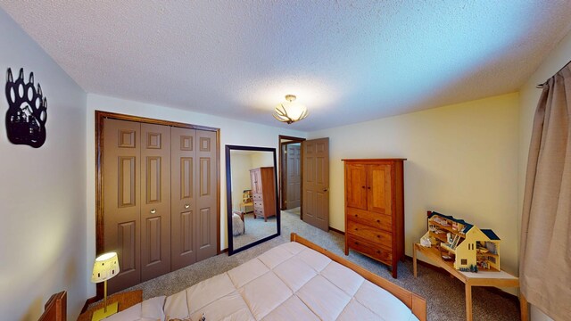 bedroom featuring light colored carpet, a closet, and a textured ceiling