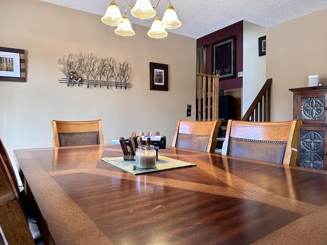 dining room featuring a textured ceiling and an inviting chandelier