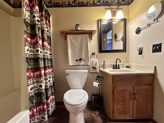 bathroom with vanity, toilet, a shower with shower curtain, and wood finished floors