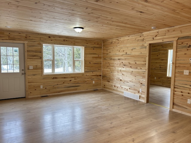 interior space featuring a wealth of natural light, light wood-type flooring, visible vents, and wooden ceiling