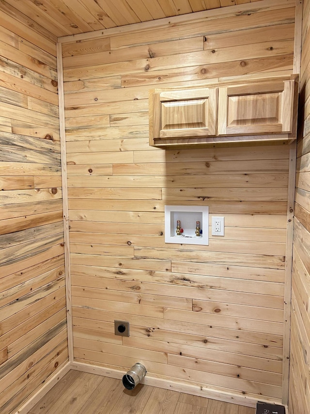 laundry room with hookup for a washing machine, wooden walls, cabinet space, and electric dryer hookup