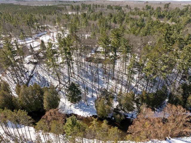 birds eye view of property featuring a wooded view