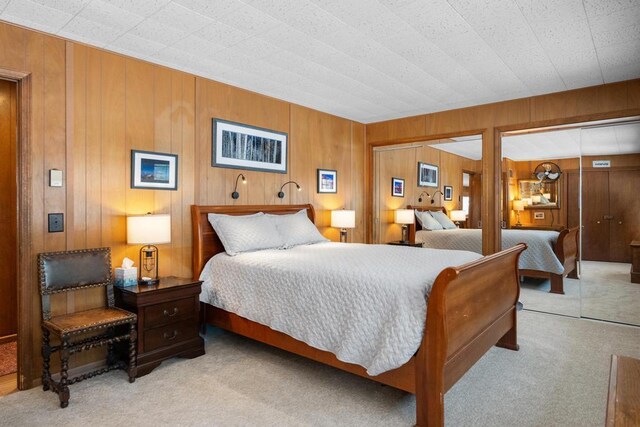 carpeted bedroom featuring two closets