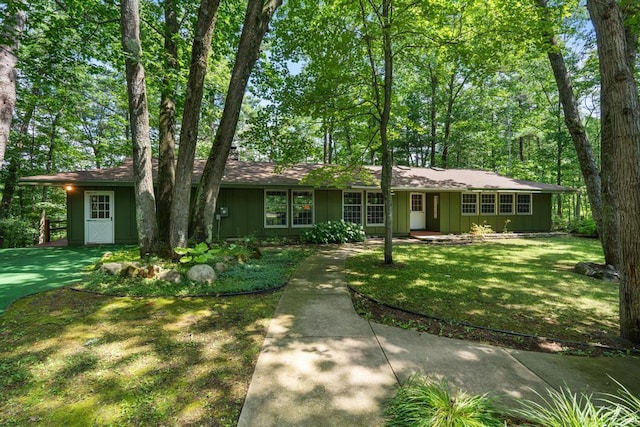 ranch-style house with a front lawn and board and batten siding