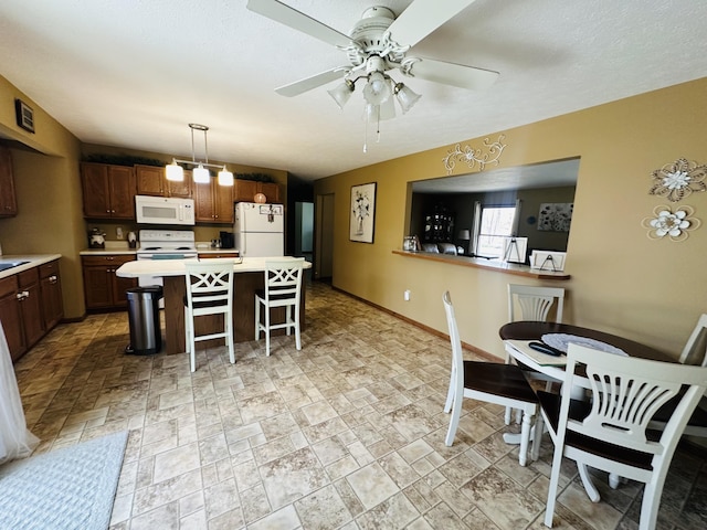 interior space featuring stone finish flooring, baseboards, and a ceiling fan