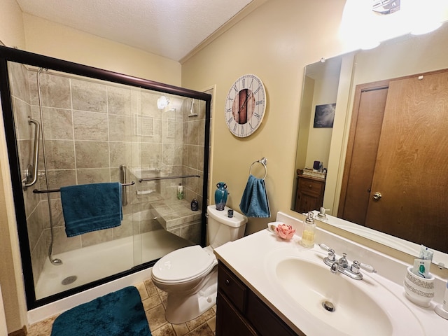 full bath featuring vanity, a stall shower, a textured ceiling, tile patterned floors, and toilet