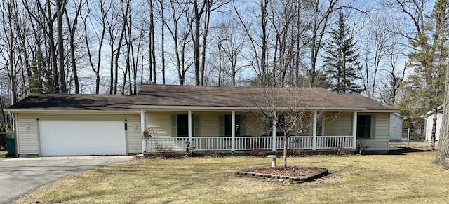 ranch-style house with a garage, a front lawn, covered porch, and driveway