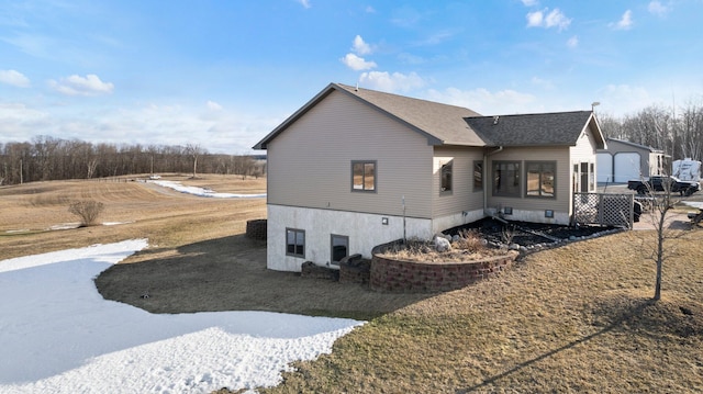 view of side of home featuring a shingled roof