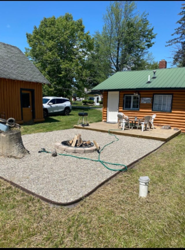 view of yard with an outdoor structure and an outdoor fire pit