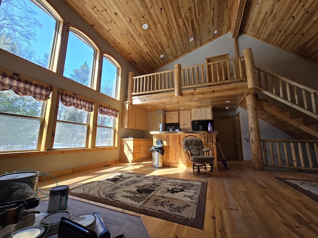 living area with beamed ceiling, wooden ceiling, high vaulted ceiling, and light wood-style floors