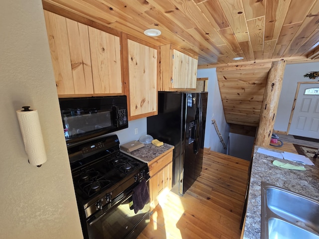 kitchen with black appliances, light wood-style flooring, light brown cabinetry, a sink, and wooden ceiling