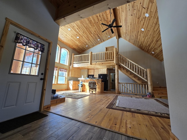 entryway with hardwood / wood-style floors, stairway, high vaulted ceiling, beam ceiling, and wood ceiling