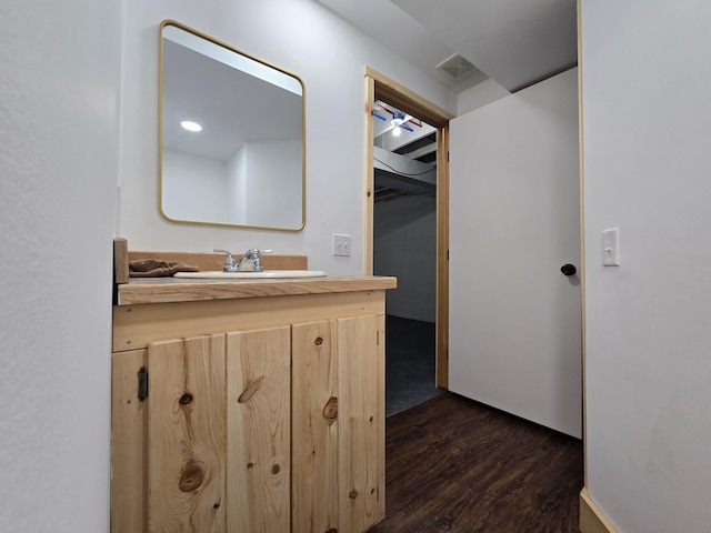 bathroom featuring visible vents, vanity, and wood finished floors