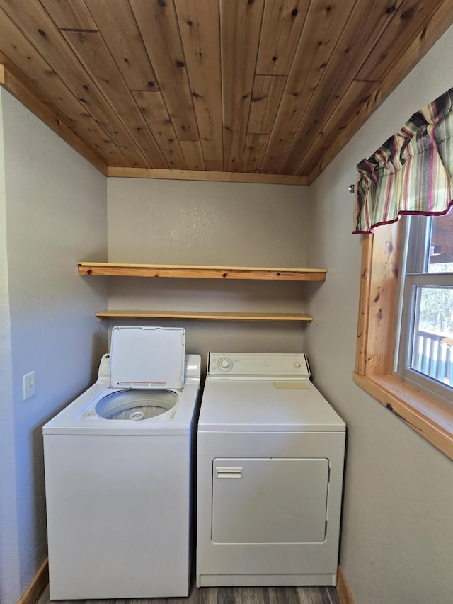 laundry room with washing machine and clothes dryer, laundry area, wooden ceiling, and baseboards