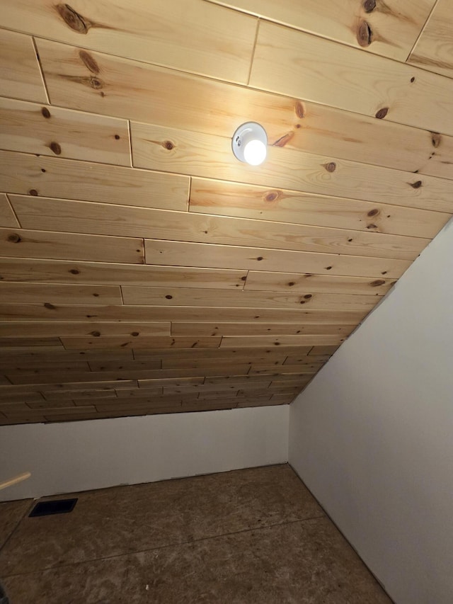 additional living space featuring vaulted ceiling and visible vents