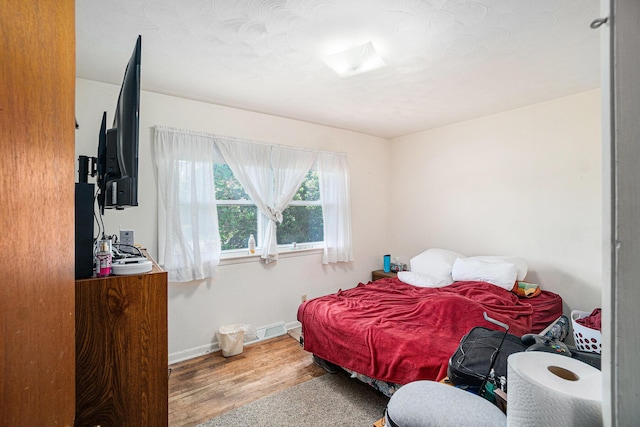 1114 Brooktrout Ln, Gaylord, MI 49735 - bedroom with wood finished floors and baseboards