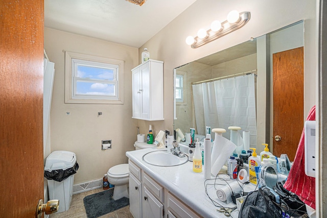 1114 Brooktrout Ln, Gaylord, MI 49735 - bathroom with toilet, vanity, curtained shower, baseboards, and tile patterned flooring