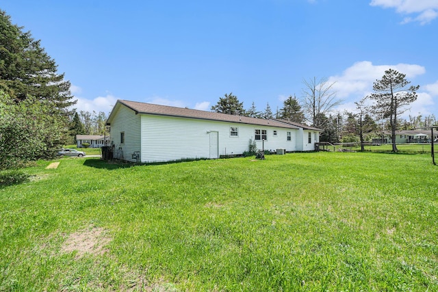 1114 Brooktrout Ln, Gaylord, MI 49735 - back of property featuring a yard