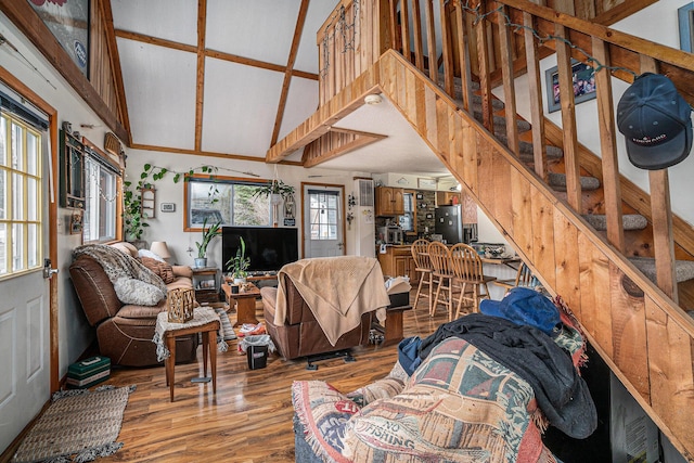 4421 Kimball Ave, Gaylord, MI 49735 - living area featuring light wood-style floors, high vaulted ceiling, and stairs